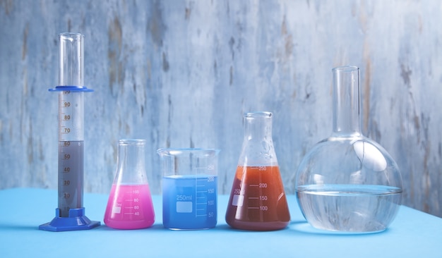 Science glassware with colored liquid.