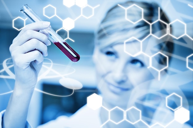 Photo science graphic against close up of a female scientist looking at a test tube