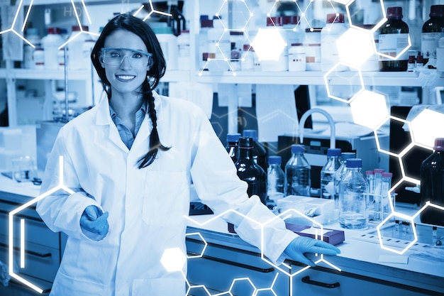 science graphic against portrait of a smiling chemist leaning against desk