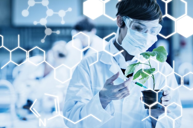 Science graphic against woman standing at the laboratory holding a plant adding chemical to soil