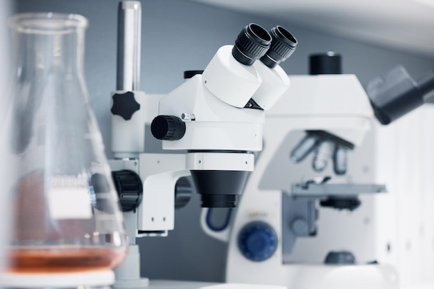 Science laboratory and microscope with pharmaceutical test for healthcare study and medicine Medical tools research and innovation in health care biotechnology and zoom on chemical investigation