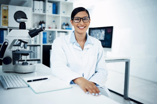 Science laboratory and portrait of woman with notebook for medical research analysis and writing notes Healthcare biotechnology and female scientist with microscope for study sample and test