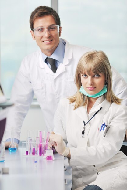 science and research biology chemistry an dmedicine  youn people couple in bright modern  lab