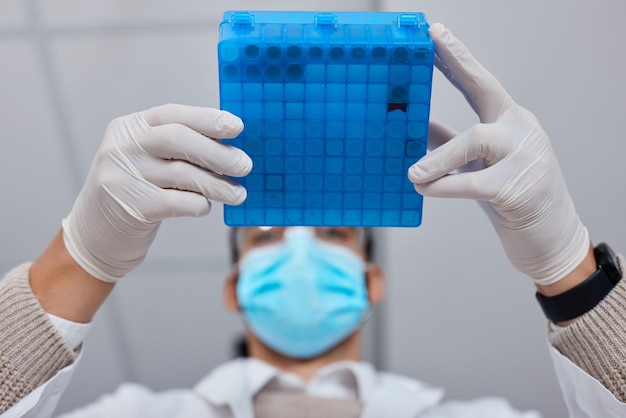 Science research and hands with a liquid container for medical innovation and vaccine analysis Healthcare lab and scientist holding vials for a dna test pharmaceutical investigation and exam