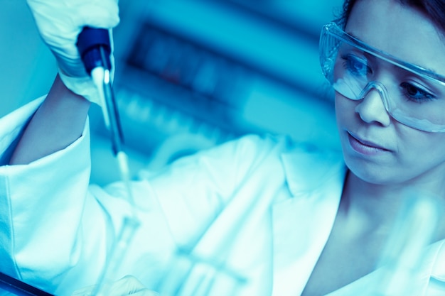 Science student dropping liquid in a test tube