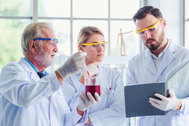 Science teacher and students team working with chemicals in lab