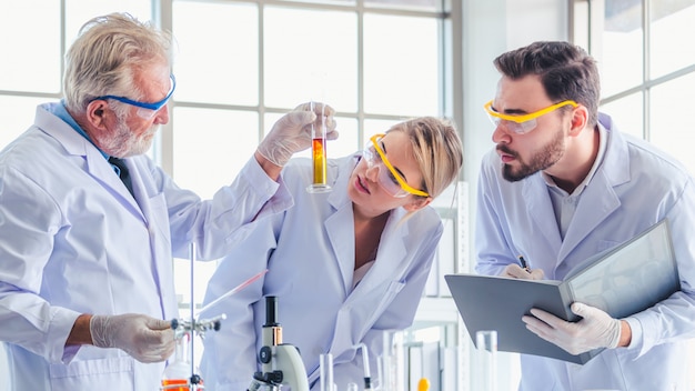 Science teacher and students team working with chemicals in lab