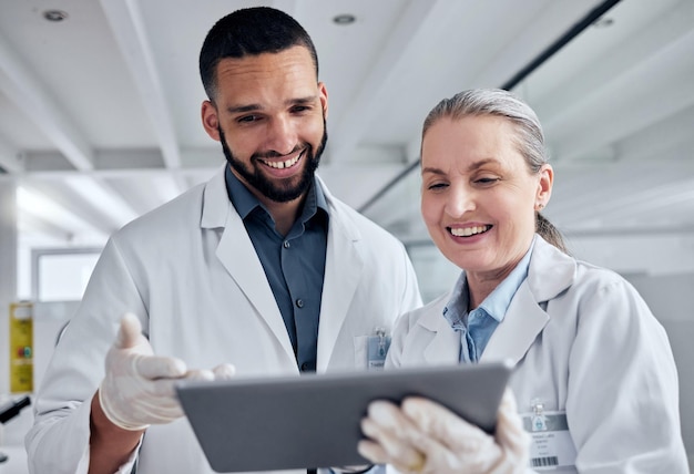 Science teamwork and tablet and scientist in laboratory for review on medical vaccine and pharmacy investigation Research innovation and digital with woman and man working on healthcare medicine