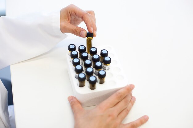 Scientific manipulating crystal test tubes in a laboratory