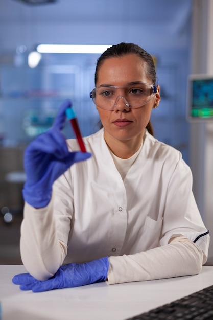 Scientific research doctor holding test tube with blood