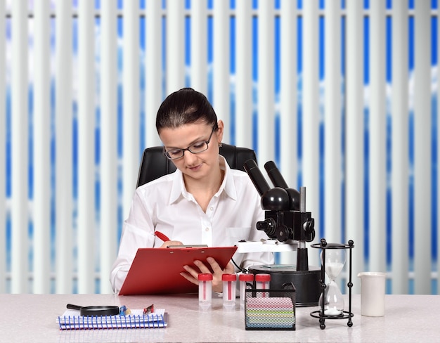 Scientific researcher writing in clipboard