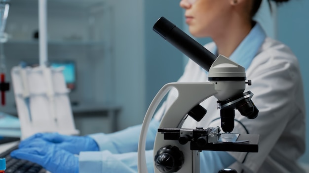 Scientific woman with microscope tool studying petri dish