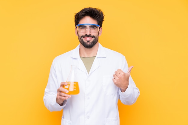 Scientific young man over isolated wall