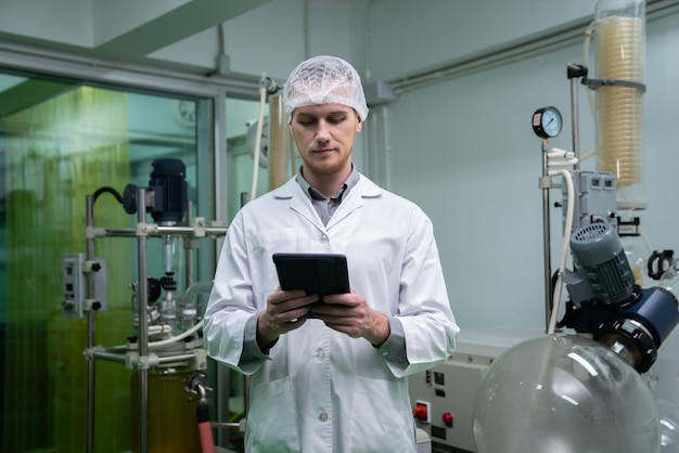 Scientist apothecary working in laboratory for cannabis extraction with tablet
