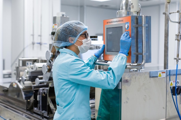 Scientist in blue suit and gas mask is checking control panel