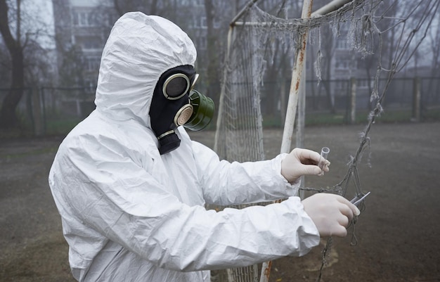 Scientist collecting samples for laboratory test on the street