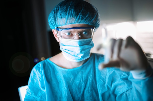 Scientist doctor in the laboratory examines the samples of the virus in vitro vaccine development c