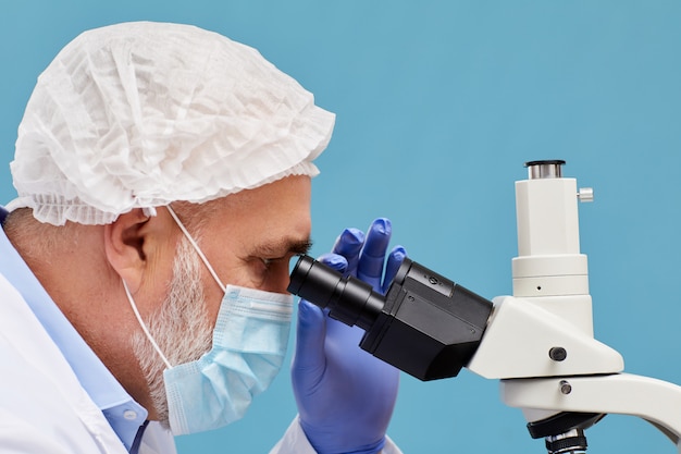 Scientist examining in microscope