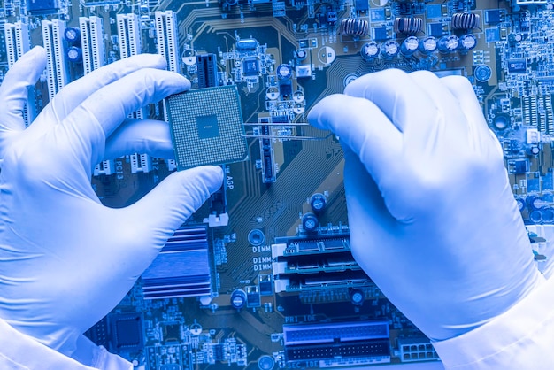 The scientist hands in gloves work with a circuit board in laboratory, close up view