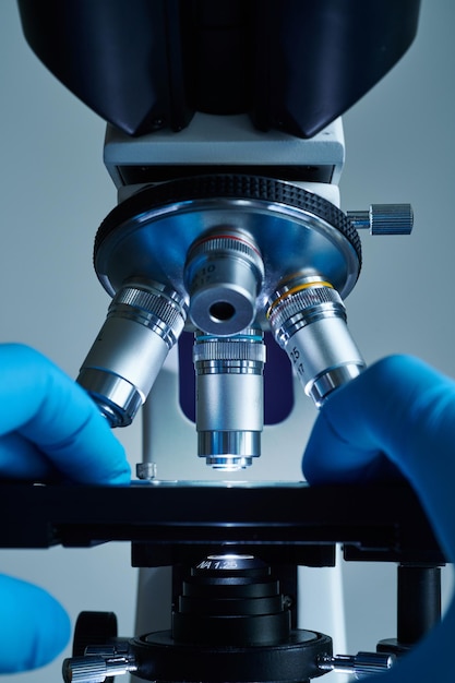 Scientist hands with microscope