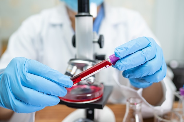 Scientist holding and analysis Coronavirus or Covid19 vaccine in laboratory