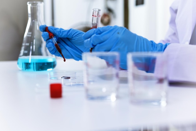 Scientist holding Coronavirus covid19 infected blood sample tube DNA testing of the blood in the laboratory with blood sample collection tubes and syringe Coronavirus Covid19 vaccine research