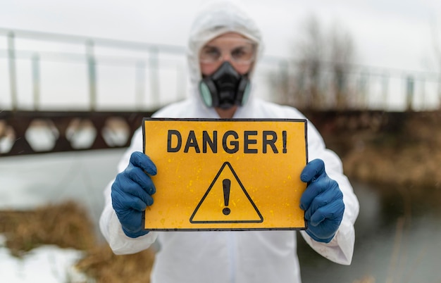 Photo scientist holding danger sign medium shot