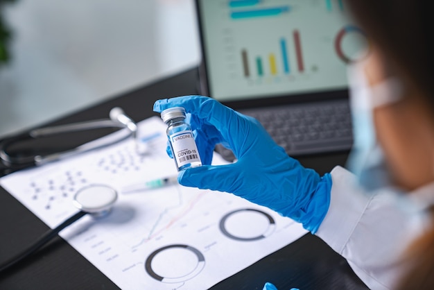 Photo scientist holding vaccine after research in lab