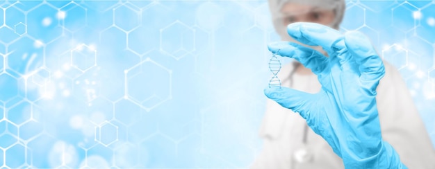 A scientist holds a 3D rendering of a DNA molecule in his hands,digital medicine genetic research