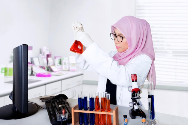 Scientist holds a chemical test tube