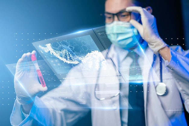 Photo a scientist holds a test tube with a red liquid in it.