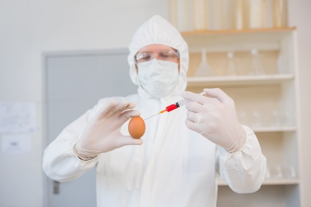 Scientist injecting egg 