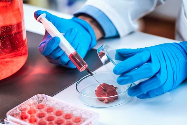 Scientist Injecting Red Substance with Syringe into Meat Sample in Petri Dish