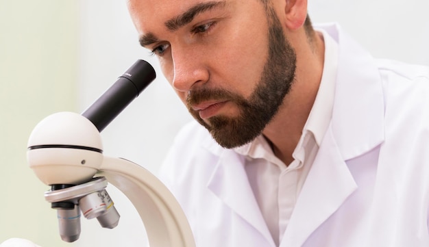 Scientist is using microscope in a laboratory during research