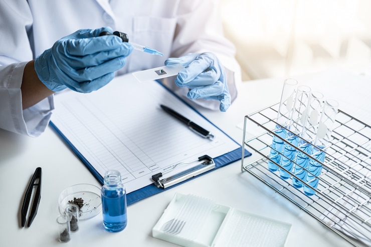 Photo scientist in lab coat working in biotechnological laboratory