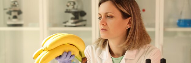 A scientist in the laboratory looks at bananas a closeup fruit certification examination