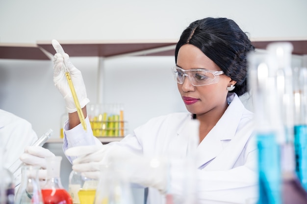 Scientist in laboratory with holding a test tube. medical\
healthcare technology and pharmaceutical research and development\
concept