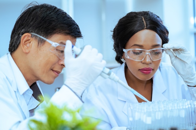 Scientist in laboratory with holding a test tube. medical healthcare technology and pharmaceutical research and development concept