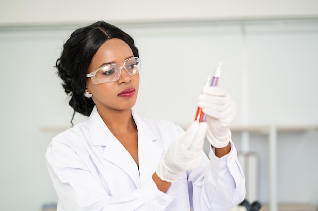 Scientist  in laboratory with holding a test tube. Medical healthcare technology and pharmaceutical research and development concept