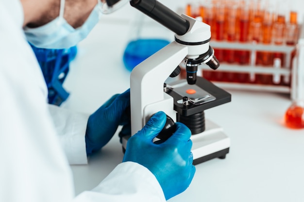 scientist looking at a control sample through a microscope