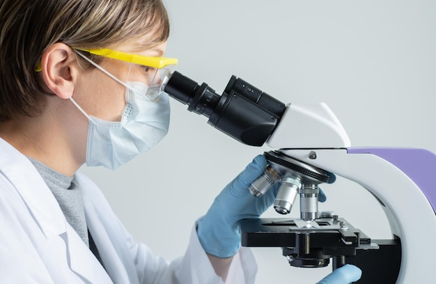 Scientist looking through a microscope