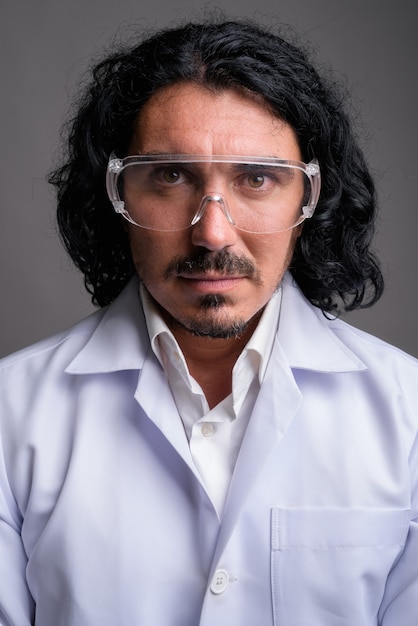 Scientist man doctor with mustache wearing protective glasses