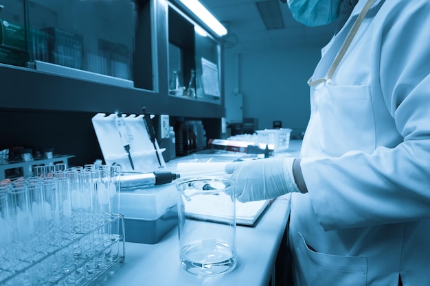 Scientist mix chemicals with The shake machine Before the experimentMixture laced with samples into test tubesThailand scientist working in the lab