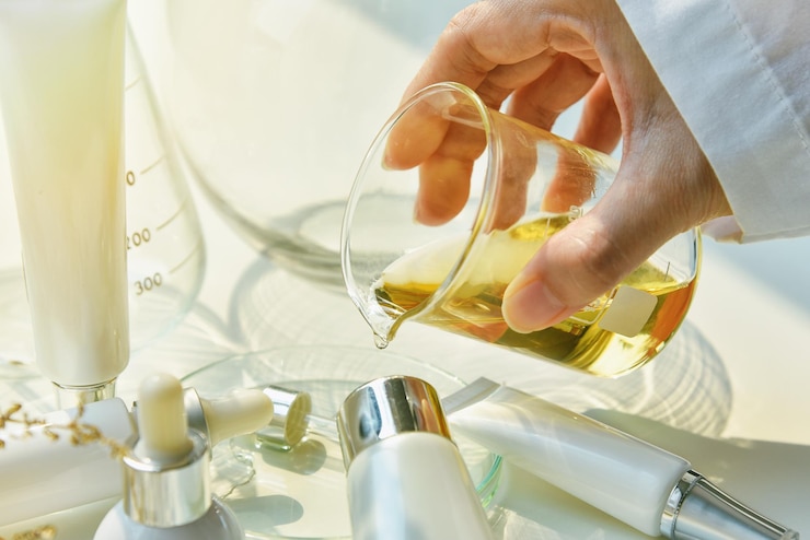 Scientist mixing natural skin care beauty products Organic botany extraction and scientific laboratory glassware Blank label cosmetic container for branding mockup
