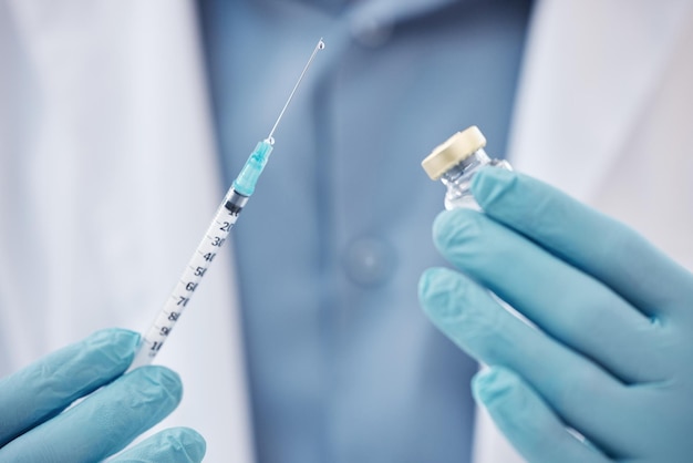 scientist needle and vial in research laboratory for medical testing experiment and healthcare breakthrough person vaccine and cure in lab with gloves on for hygiene safety and treatment