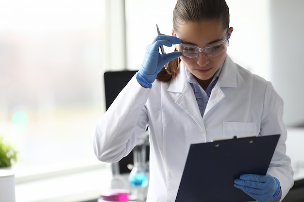 Photo scientist noting information of researching