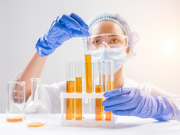 Scientist pouring organic oil.