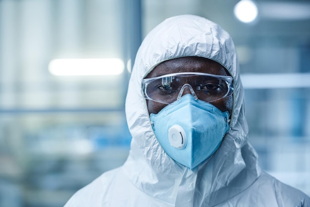 scientist in protective wear working in laboratory
