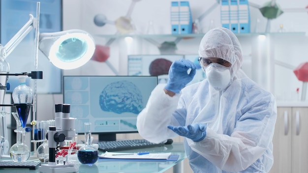 Scientist researcher engineer doctor wearing ppe equipment analyzing artificial intelligence using augmented reality software during biochemistry experiment in hospital laboratory. Medicine concept