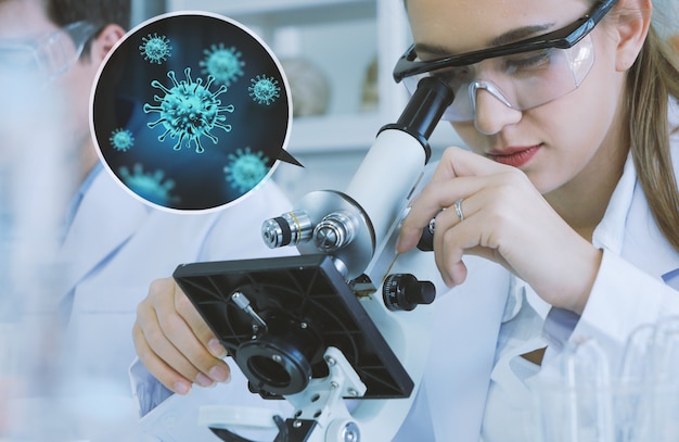 Photo scientist researcher using microscope in laboratory